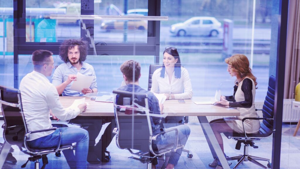 A diverse startup team collaborating in a workspace, showcasing strategies for building a high-performing team for low-investment startups.